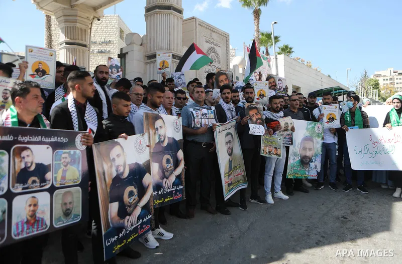 Palestinians take part in a protest in solidarity with prisoners on hunger strike at Israeli jails, in the West Bank city on October 24, 2021. Seven Palestinian prisoners in Israeli detention currently remain on hunger s...