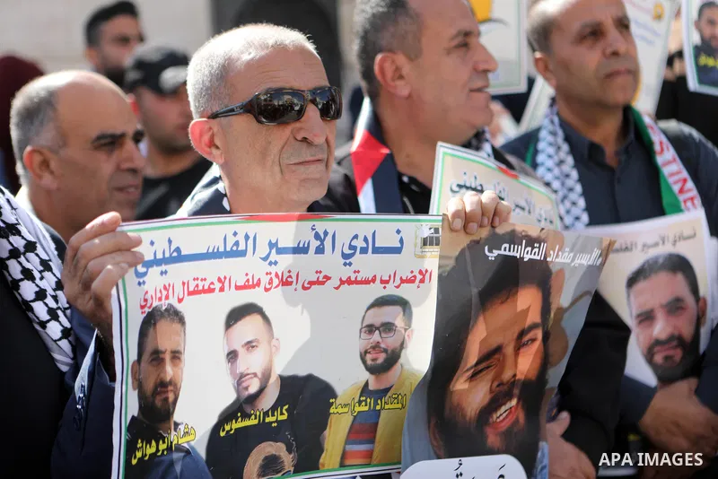 Palestinians take part in a protest in solidarity with prisoners on hunger strike at Israeli jails, in the West Bank city on October 24, 2021. Seven Palestinian prisoners in Israeli detention currently remain on hunger s...