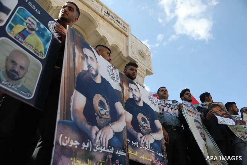 Palestinians take part in a protest in solidarity with prisoners on hunger strike at Israeli jails, in the West Bank city on October 24, 2021. Seven Palestinian prisoners in Israeli detention currently remain on hunger s...
