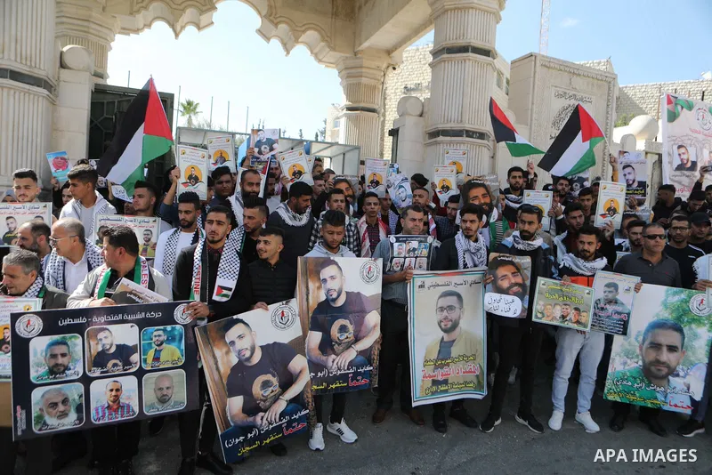 Palestinians take part in a protest in solidarity with prisoners on hunger strike at Israeli jails, in the West Bank city on October 24, 2021. Seven Palestinian prisoners in Israeli detention currently remain on hunger s...