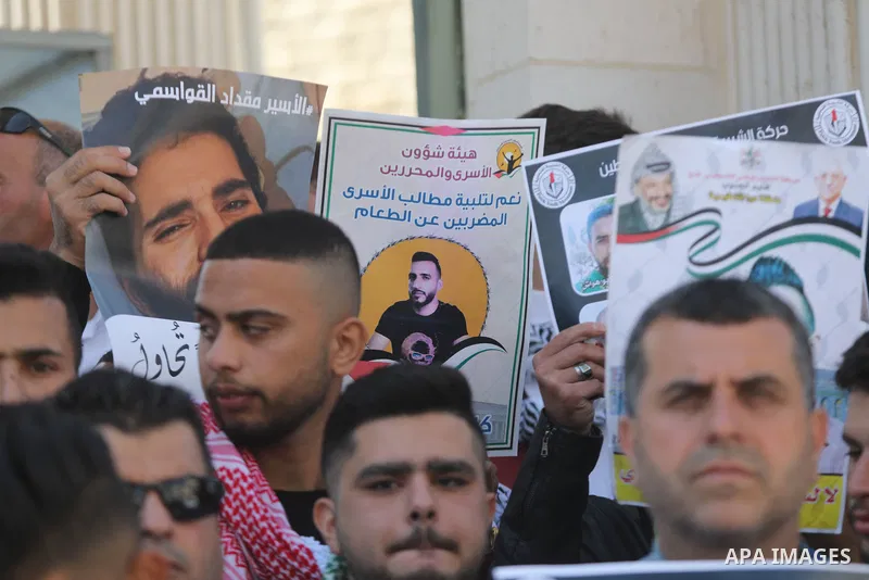 Palestinians take part in a protest in solidarity with prisoners on hunger strike at Israeli jails, in the West Bank city on October 24, 2021. Seven Palestinian prisoners in Israeli detention currently remain on hunger s...