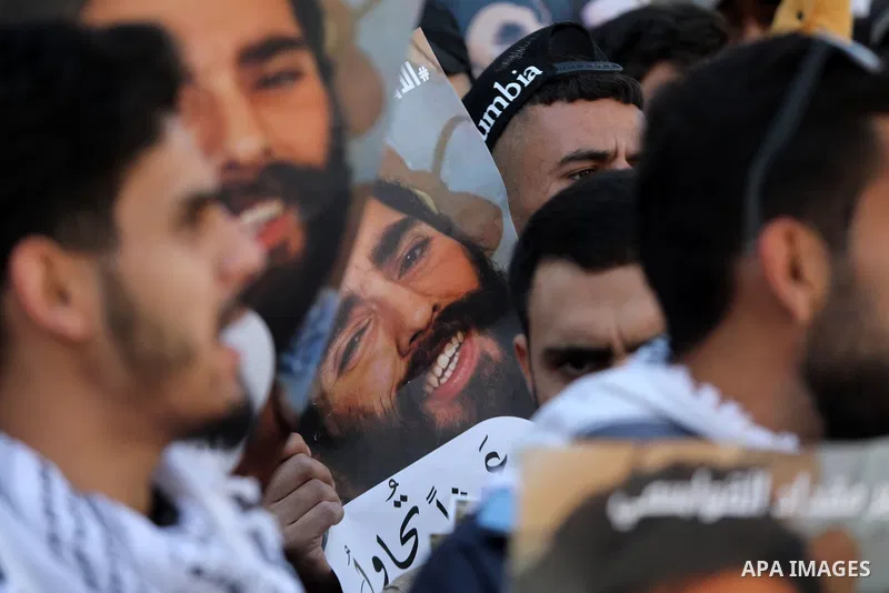 Palestinians take part in a protest in solidarity with prisoners on hunger strike at Israeli jails, in the West Bank city on October 24, 2021. Seven Palestinian prisoners in Israeli detention currently remain on hunger s...
