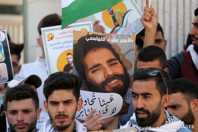 Palestinians take part in a protest in solidarity with prisoners on hunger strike at Israeli jails, in the West Bank city on October 24, 2021. Seven Palestinian prisoners in Israeli detention currently remain on hunger s...