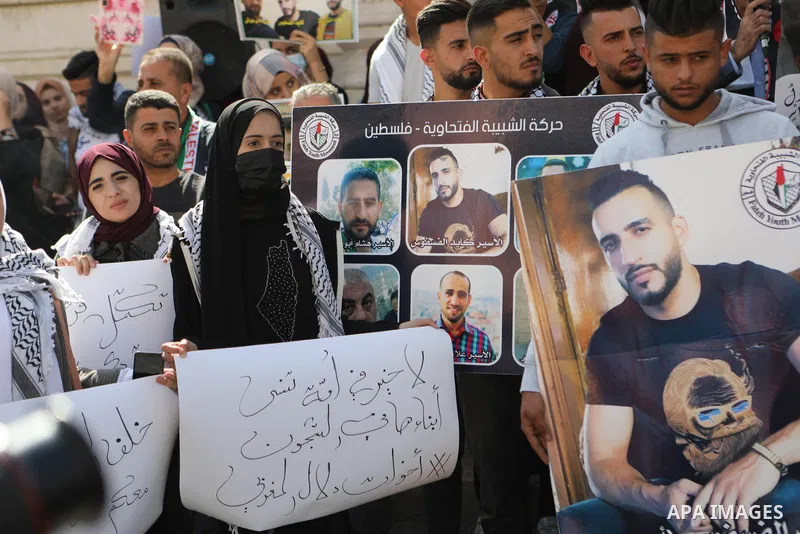 Palestinians take part in a protest in solidarity with prisoners on hunger strike at Israeli jails, in the West Bank city on October 24, 2021. Seven Palestinian prisoners in Israeli detention currently remain on hunger s...