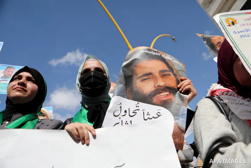Palestinians take part in a protest in solidarity with prisoners on hunger strike at Israeli jails, in the West Bank city on October 24, 2021. Seven Palestinian prisoners in Israeli detention currently remain on hunger s...