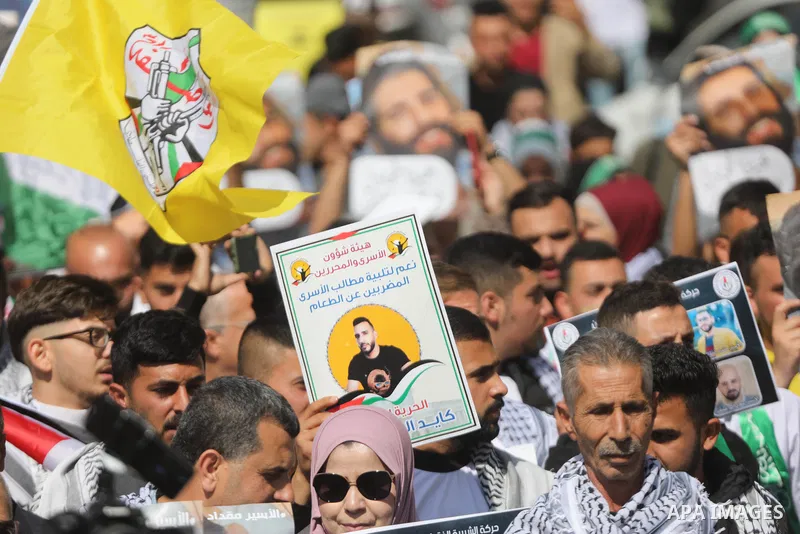 Palestinians take part in a protest in solidarity with prisoners on hunger strike at Israeli jails, in the West Bank city on October 24, 2021. Seven Palestinian prisoners in Israeli detention currently remain on hunger s...
