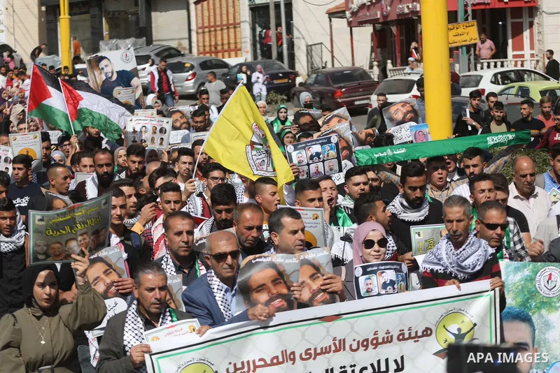 Palestinians take part in a protest in solidarity with prisoners on hunger strike at Israeli jails, in the West Bank city on October 24, 2021. Seven Palestinian prisoners in Israeli detention currently remain on hunger s...