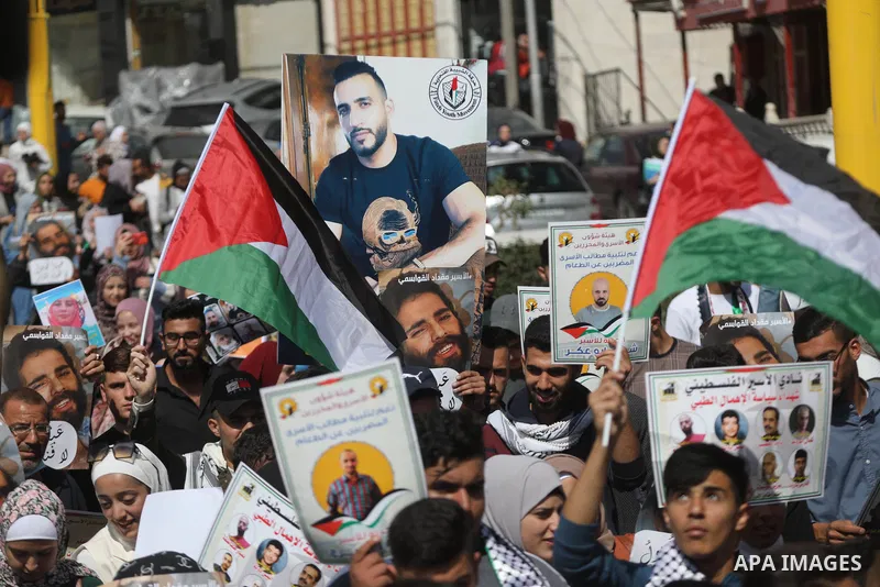 Palestinians take part in a protest in solidarity with prisoners on hunger strike at Israeli jails, in the West Bank city on October 24, 2021. Seven Palestinian prisoners in Israeli detention currently remain on hunger s...