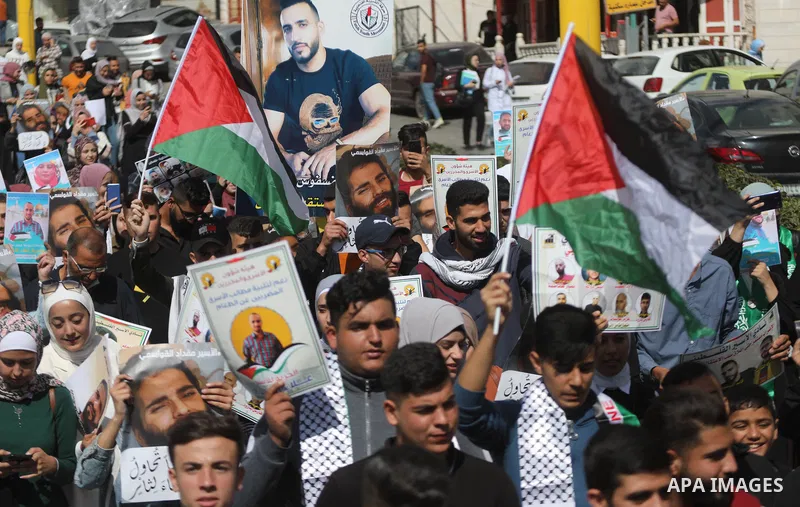 Palestinians take part in a protest in solidarity with prisoners on hunger strike at Israeli jails, in the West Bank city on October 24, 2021. Seven Palestinian prisoners in Israeli detention currently remain on hunger s...