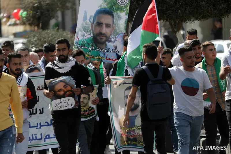 Palestinians take part in a protest in solidarity with prisoners on hunger strike at Israeli jails, in the West Bank city on October 24, 2021. Seven Palestinian prisoners in Israeli detention currently remain on hunger s...