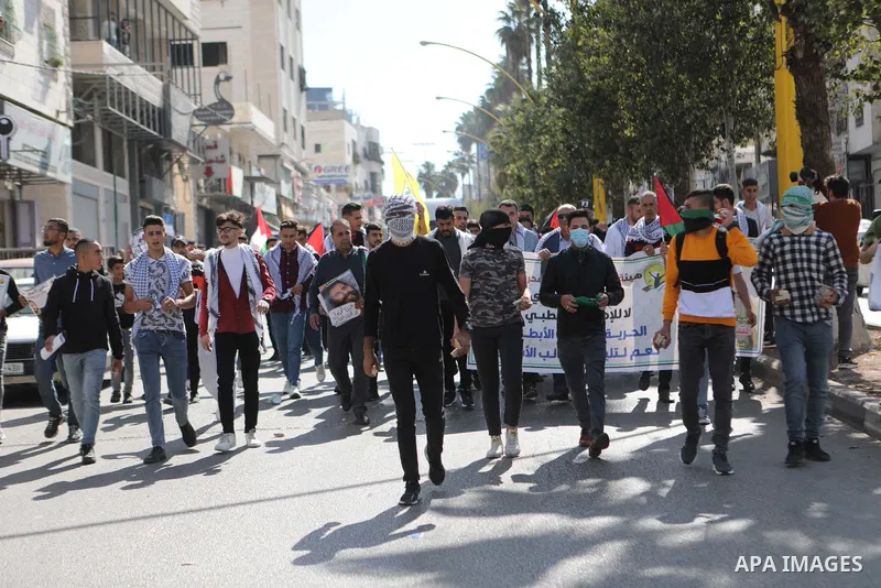 Palestinians take part in a protest in solidarity with prisoners on hunger strike at Israeli jails, in the West Bank city on October 24, 2021. Seven Palestinian prisoners in Israeli detention currently remain on hunger s...