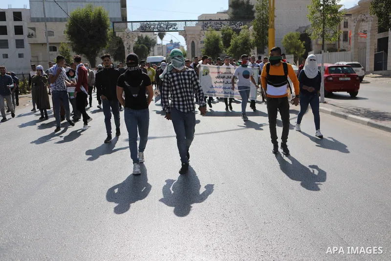 Palestinians take part in a protest in solidarity with prisoners on hunger strike at Israeli jails, in the West Bank city on October 24, 2021. Seven Palestinian prisoners in Israeli detention currently remain on hunger s...