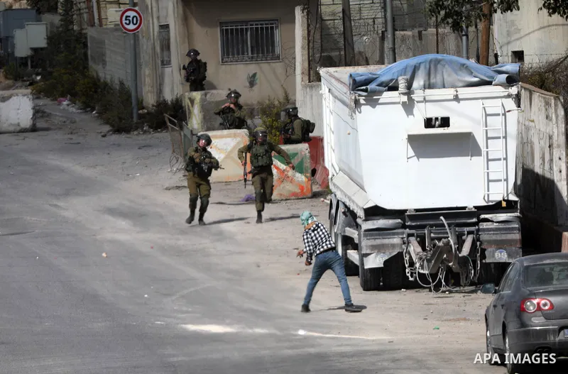 Palestinian protesters clash with Israeli forces following a demonstration calling for the release of Palestinian prisoners on hunger strike in Israeli jails, in the West Bank city of Hebron on October 24, 2021. Seven Pa...