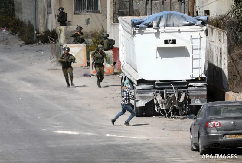 Palestinian protesters clash with Israeli forces following a demonstration calling for the release of Palestinian prisoners on hunger strike in Israeli jails, in the West Bank city of Hebron on October 24, 2021. Seven Pa...