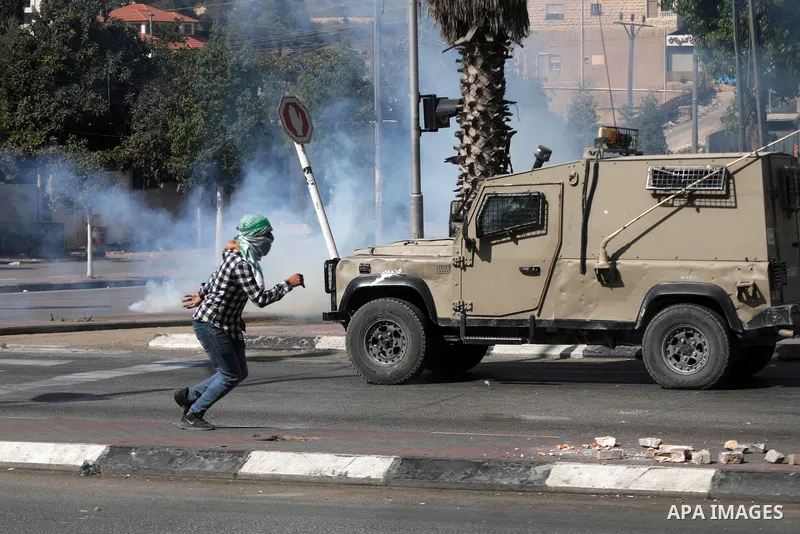 Palestinian protesters clash with Israeli forces following a demonstration calling for the release of Palestinian prisoners on hunger strike in Israeli jails, in the West Bank city of Hebron on October 24, 2021. Seven Pa...