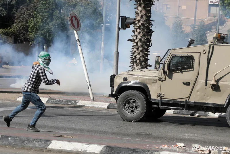 Palestinian protesters clash with Israeli forces following a demonstration calling for the release of Palestinian prisoners on hunger strike in Israeli jails, in the West Bank city of Hebron on October 24, 2021. Seven Pa...