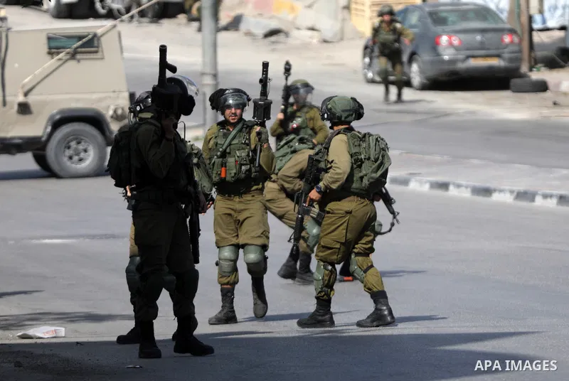 Palestinian protesters clash with Israeli forces following a demonstration calling for the release of Palestinian prisoners on hunger strike in Israeli jails, in the West Bank city of Hebron on October 24, 2021. Seven Pa...