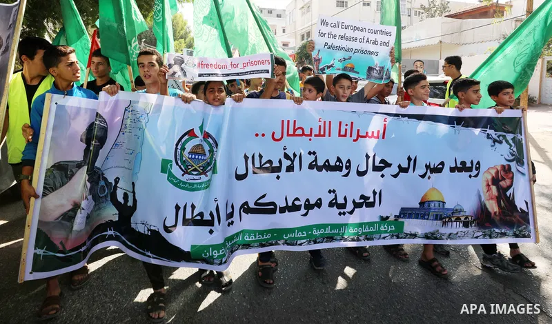 Palestinian children hold banners during a protest in solidarity with prisoners on hunger strike at Israeli jails, in front of Red Cross office in Gaza city on October 25, 2021. Photo by Mahmoud Nasser