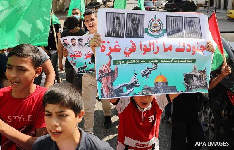 Palestinian children hold banners during a protest in solidarity with prisoners on hunger strike at Israeli jails, in front of Red Cross office in Gaza city on October 25, 2021. Photo by Mahmoud Nasser