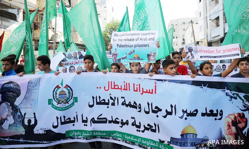 Palestinian children hold banners during a protest in solidarity with prisoners on hunger strike at Israeli jails, in front of Red Cross office in Gaza city on October 25, 2021. Photo by Mahmoud Nasser