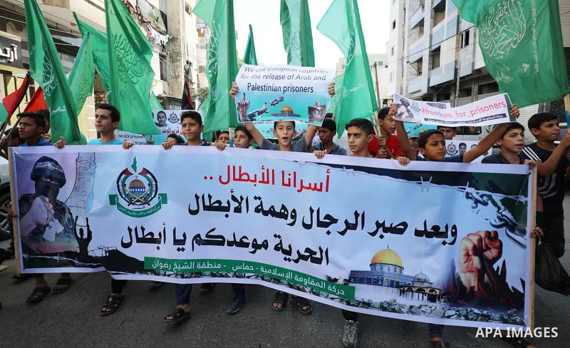 Palestinian children hold banners during a protest in solidarity with prisoners on hunger strike at Israeli jails, in front of Red Cross office in Gaza city on October 25, 2021. Photo by Mahmoud Nasser