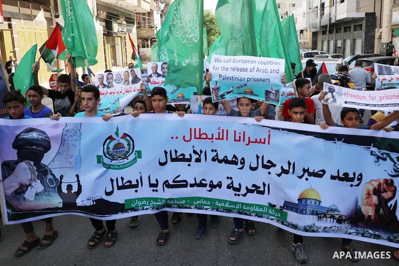 Palestinian children hold banners during a protest in solidarity with prisoners on hunger strike at Israeli jails, in front of Red Cross office in Gaza city on October 25, 2021. Photo by Mahmoud Nasser