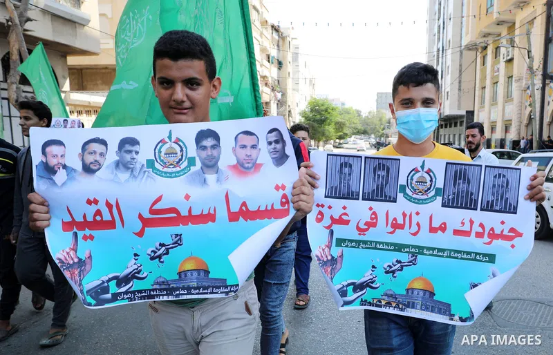 Palestinian children hold banners during a protest in solidarity with prisoners on hunger strike at Israeli jails, in front of Red Cross office in Gaza city on October 25, 2021. Photo by Mahmoud Nasser