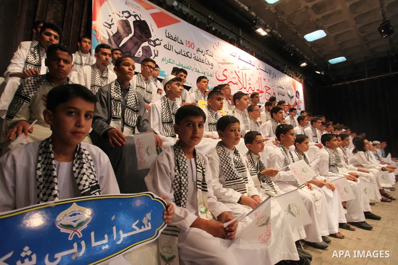 Palestinian children participate in a ceremony to honor the memorizers of the Holy Koran, in Gaza city on October 25, 2021. Photo by Omar Ashtawy