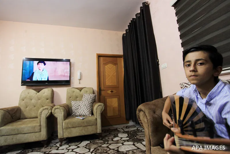 Palestinian boy Samih al Madhoun, 14, plays the oud and sings at his home, in Gaza city on October 26, 2021. al-Madhoun said that the passion for singing and composing is a talent that I worked a lot on developing and br...