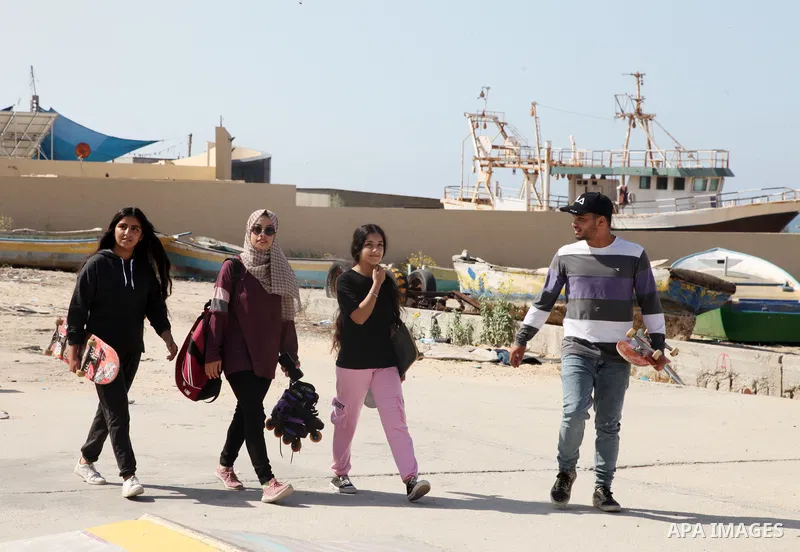 Palestinian girls practice on Skateboard sport at Gaza seaport, in Gaza city on October 27, 2021. A skateboard is a type of sports equipment used for skateboarding. They are usually made of a specially designed 7-8 ply m...