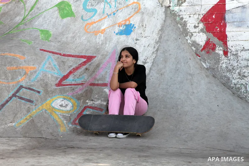 Palestinian girls practice on Skateboard sport at Gaza seaport, in Gaza city on October 27, 2021. A skateboard is a type of sports equipment used for skateboarding. They are usually made of a specially designed 7-8 ply m...