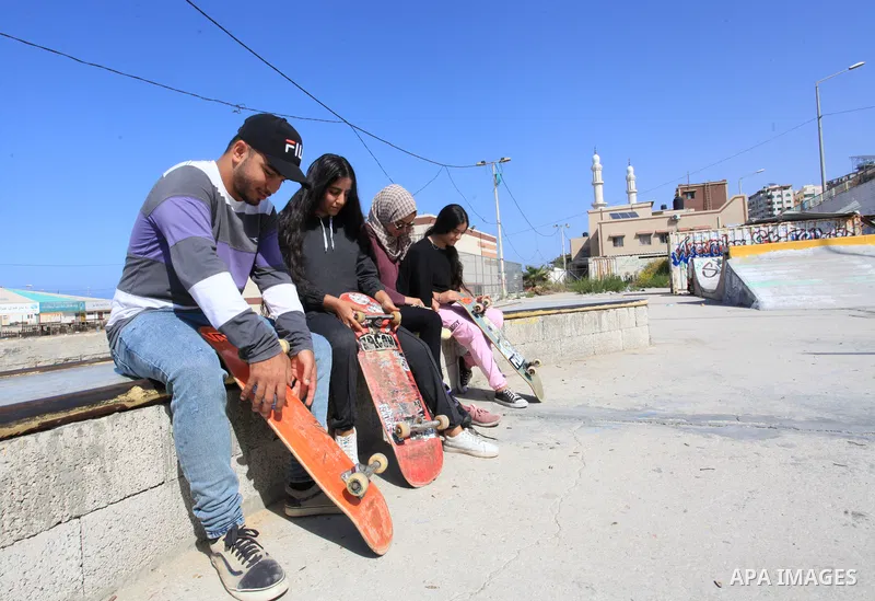 Palestinian girls practice on Skateboard sport at Gaza seaport, in Gaza city on October 27, 2021. A skateboard is a type of sports equipment used for skateboarding. They are usually made of a specially designed 7-8 ply m...