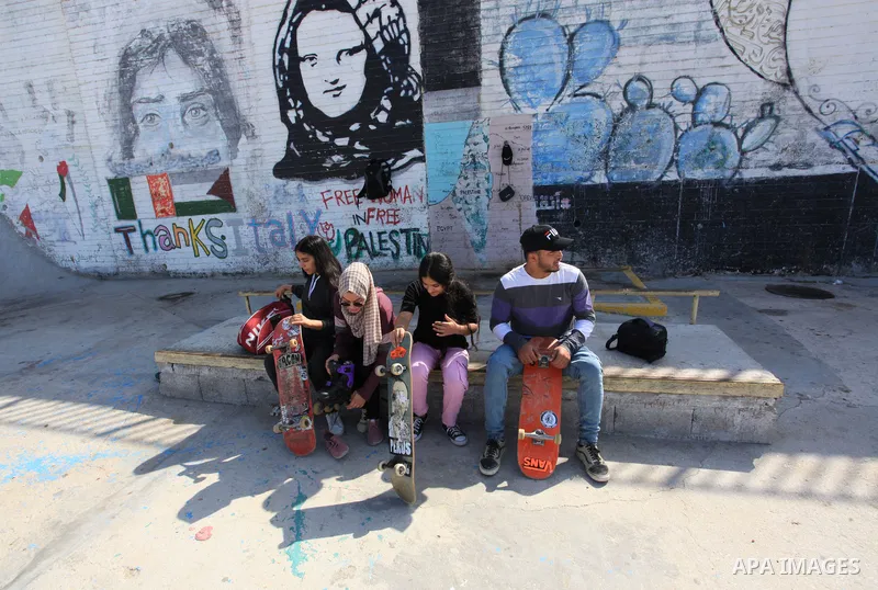 Palestinian girls practice on Skateboard sport at Gaza seaport, in Gaza city on October 27, 2021. A skateboard is a type of sports equipment used for skateboarding. They are usually made of a specially designed 7-8 ply m...