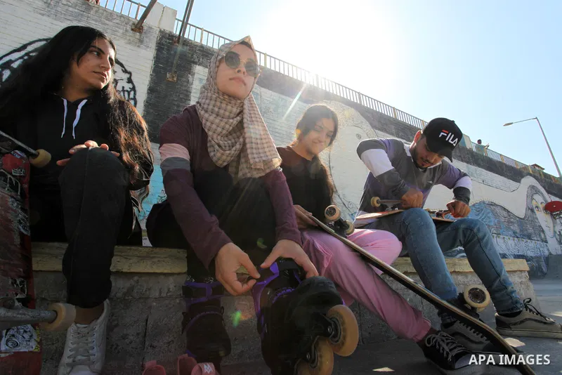 Palestinian girls practice on Skateboard sport at Gaza seaport, in Gaza city on October 27, 2021. A skateboard is a type of sports equipment used for skateboarding. They are usually made of a specially designed 7-8 ply m...