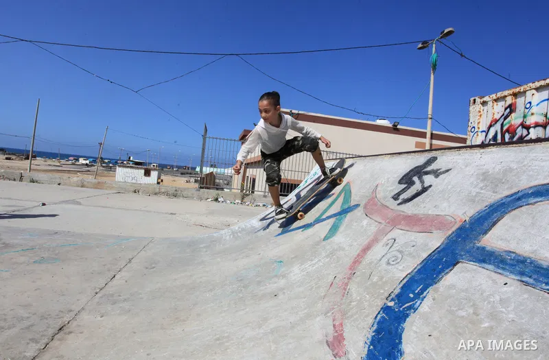 Palestinian girls practice on Skateboard sport at Gaza seaport, in Gaza city on October 27, 2021. A skateboard is a type of sports equipment used for skateboarding. They are usually made of a specially designed 7-8 ply m...