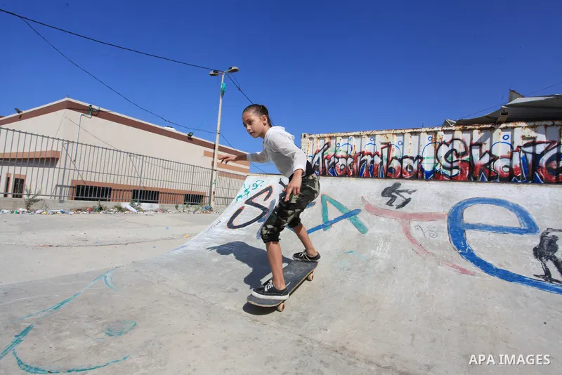 Palestinian girls practice on Skateboard sport at Gaza seaport, in Gaza city on October 27, 2021. A skateboard is a type of sports equipment used for skateboarding. They are usually made of a specially designed 7-8 ply m...