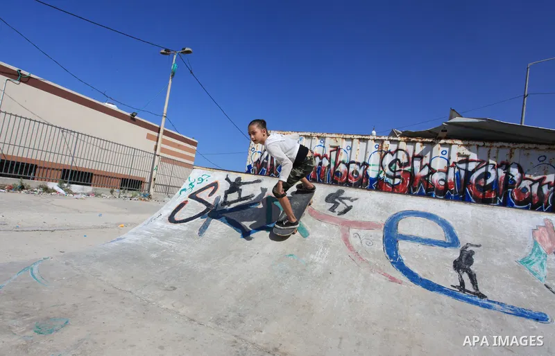 Palestinian girls practice on Skateboard sport at Gaza seaport, in Gaza city on October 27, 2021. A skateboard is a type of sports equipment used for skateboarding. They are usually made of a specially designed 7-8 ply m...