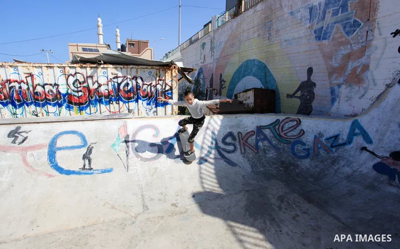 Palestinian girls practice on Skateboard sport at Gaza seaport, in Gaza city on October 27, 2021. A skateboard is a type of sports equipment used for skateboarding. They are usually made of a specially designed 7-8 ply m...