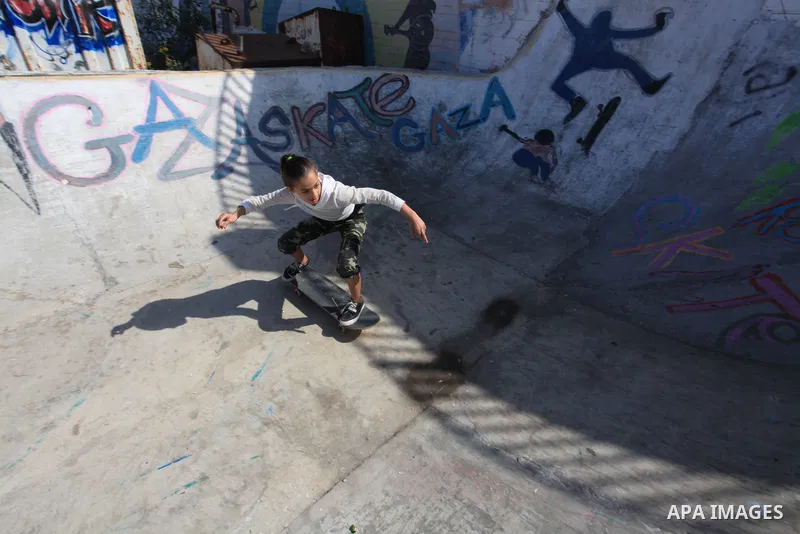 Palestinian girls practice on Skateboard sport at Gaza seaport, in Gaza city on October 27, 2021. A skateboard is a type of sports equipment used for skateboarding. They are usually made of a specially designed 7-8 ply m...