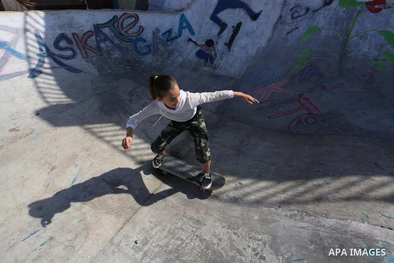 Palestinian girls practice on Skateboard sport at Gaza seaport, in Gaza city on October 27, 2021. A skateboard is a type of sports equipment used for skateboarding. They are usually made of a specially designed 7-8 ply m...