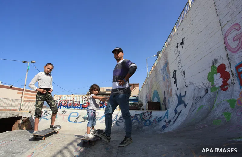 Palestinian girls practice on Skateboard sport at Gaza seaport, in Gaza city on October 27, 2021. A skateboard is a type of sports equipment used for skateboarding. They are usually made of a specially designed 7-8 ply m...