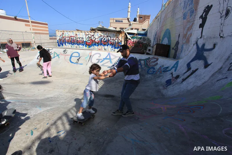 Palestinian girls practice on Skateboard sport at Gaza seaport, in Gaza city on October 27, 2021. A skateboard is a type of sports equipment used for skateboarding. They are usually made of a specially designed 7-8 ply m...