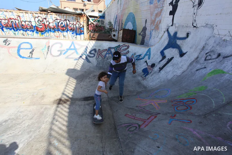 Palestinian girls practice on Skateboard sport at Gaza seaport, in Gaza city on October 27, 2021. A skateboard is a type of sports equipment used for skateboarding. They are usually made of a specially designed 7-8 ply m...