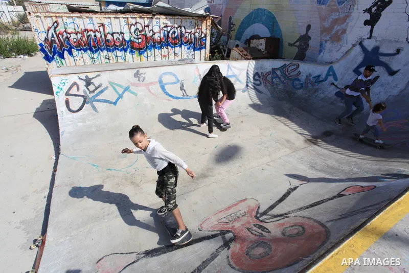 Palestinian girls practice on Skateboard sport at Gaza seaport, in Gaza city on October 27, 2021. A skateboard is a type of sports equipment used for skateboarding. They are usually made of a specially designed 7-8 ply m...
