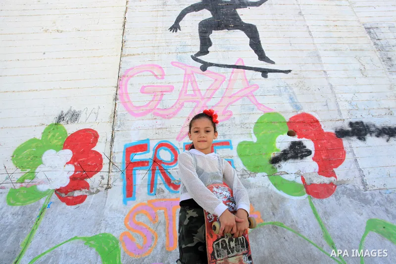 Palestinian girls practice on Skateboard sport at Gaza seaport, in Gaza city on October 27, 2021. A skateboard is a type of sports equipment used for skateboarding. They are usually made of a specially designed 7-8 ply m...