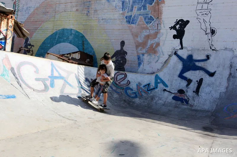 Palestinian girls practice on Skateboard sport at Gaza seaport, in Gaza city on October 27, 2021. A skateboard is a type of sports equipment used for skateboarding. They are usually made of a specially designed 7-8 ply m...