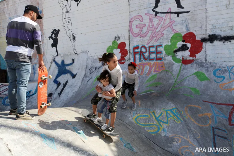 Palestinian girls practice on Skateboard sport at Gaza seaport, in Gaza city on October 27, 2021. A skateboard is a type of sports equipment used for skateboarding. They are usually made of a specially designed 7-8 ply m...