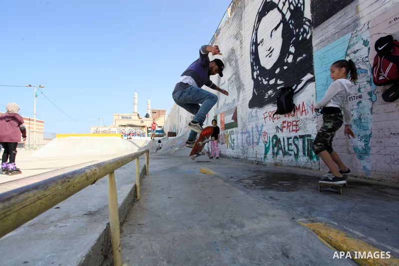 Palestinian girls practice on Skateboard sport at Gaza seaport, in Gaza city on October 27, 2021. A skateboard is a type of sports equipment used for skateboarding. They are usually made of a specially designed 7-8 ply m...