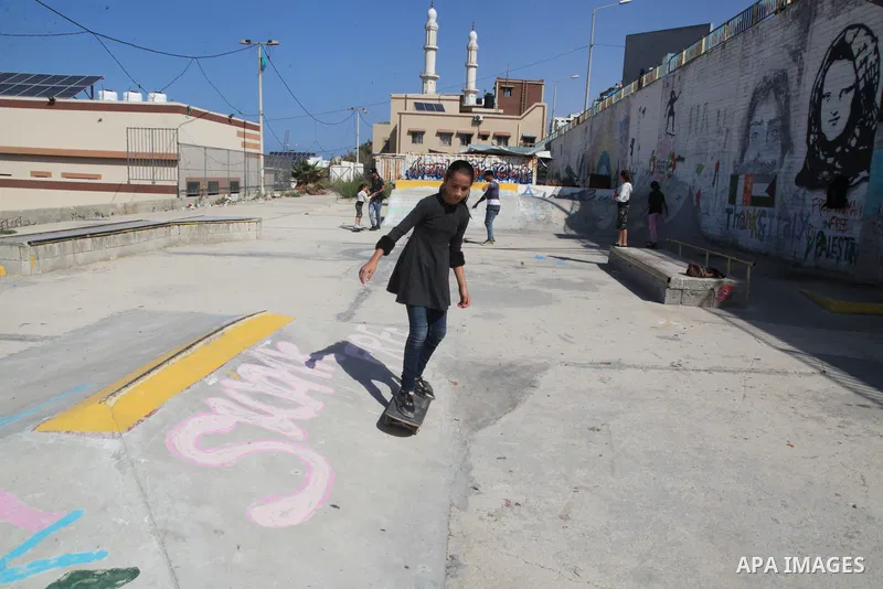Palestinian girls practice on Skateboard sport at Gaza seaport, in Gaza city on October 27, 2021. A skateboard is a type of sports equipment used for skateboarding. They are usually made of a specially designed 7-8 ply m...