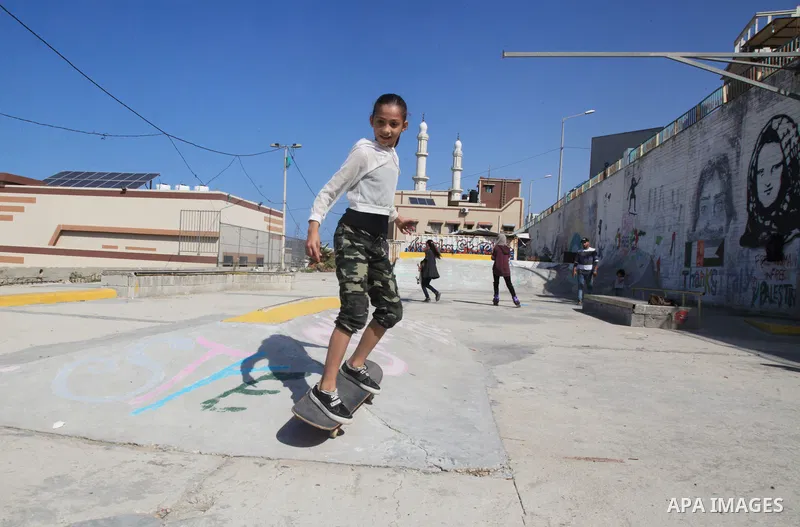Palestinian girls practice on Skateboard sport at Gaza seaport, in Gaza city on October 27, 2021. A skateboard is a type of sports equipment used for skateboarding. They are usually made of a specially designed 7-8 ply m...